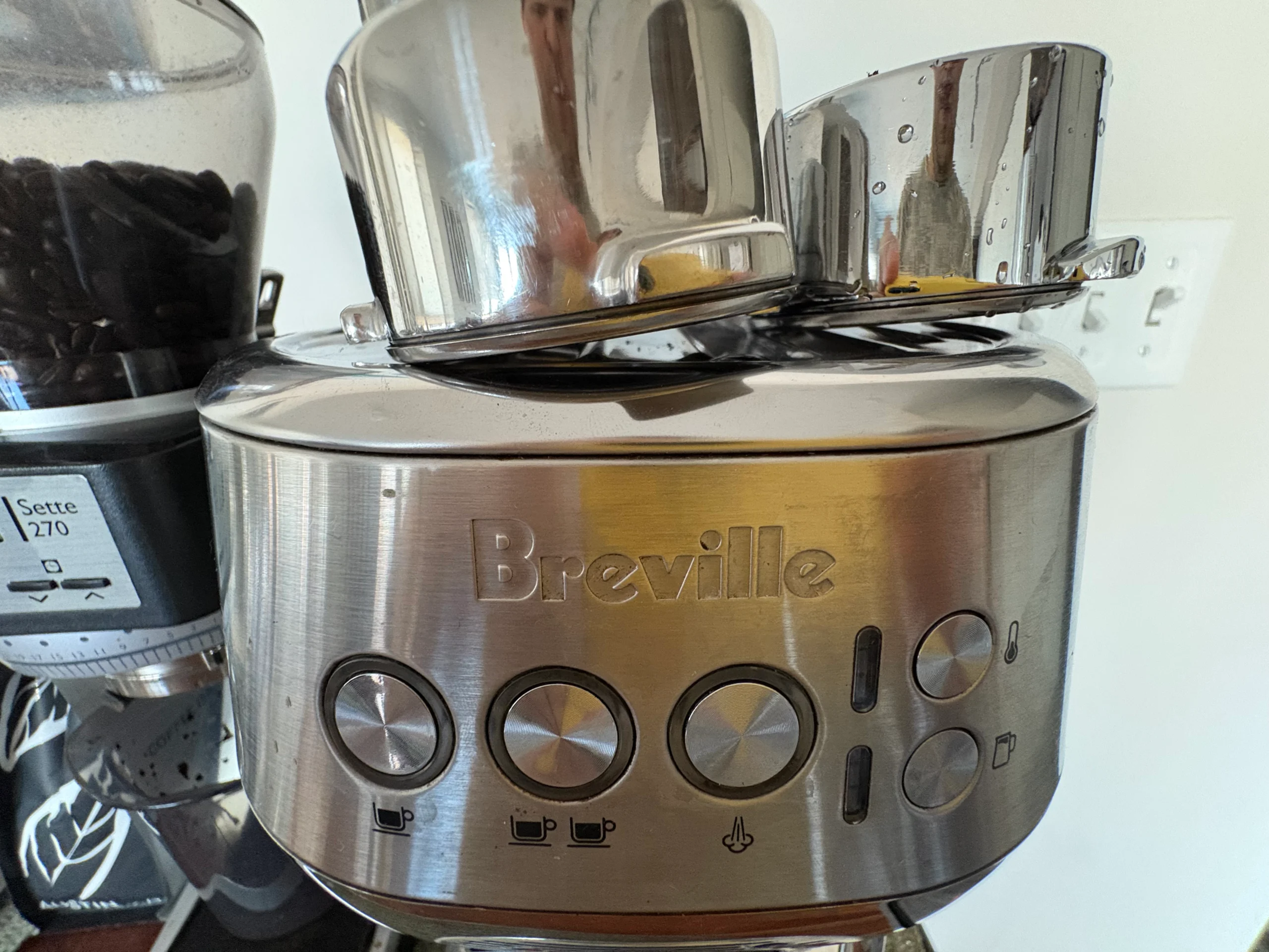 Close-up of the Breville logo on a Breville Bambino Plus espresso machine.