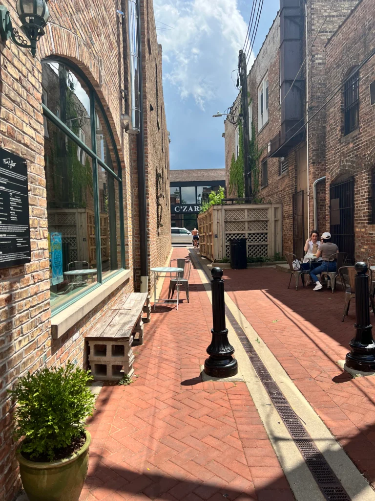 A charming brick-paved alleyway leading to Five & Hoek Coffee in Wheaton, IL